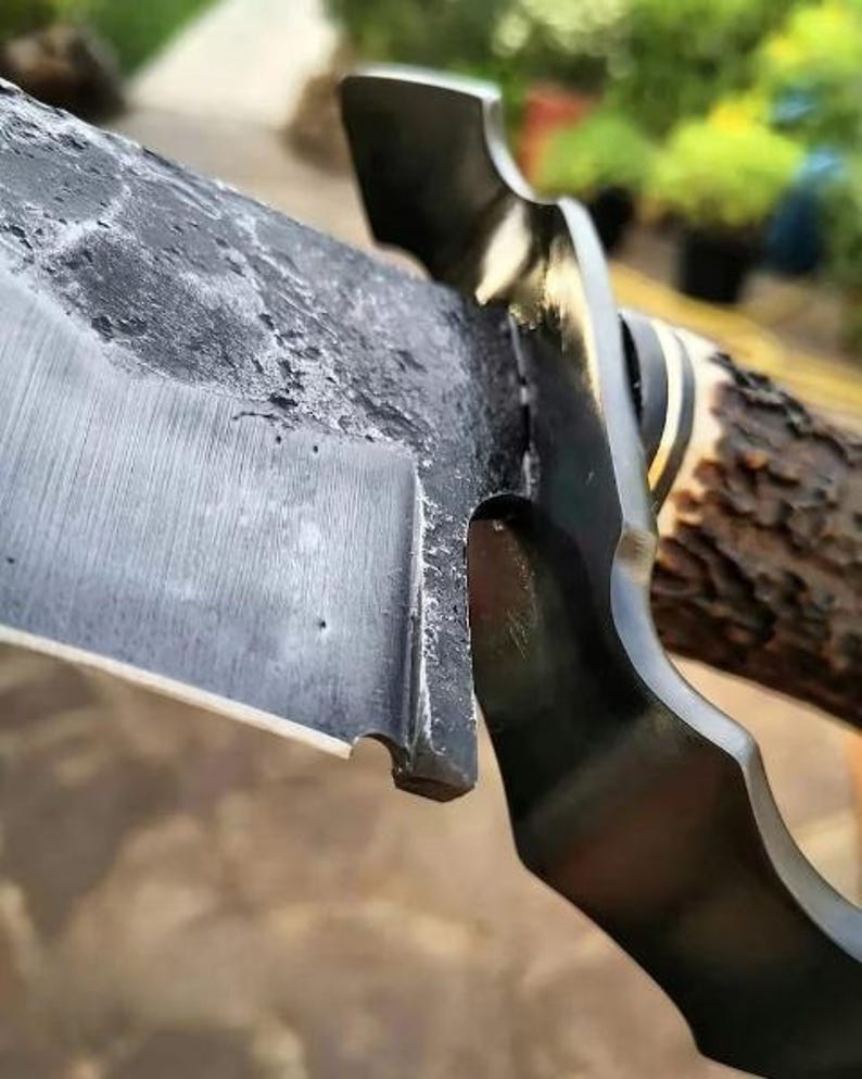 Close-up of a multi-tool with a blade and other tools on a blurred natural background