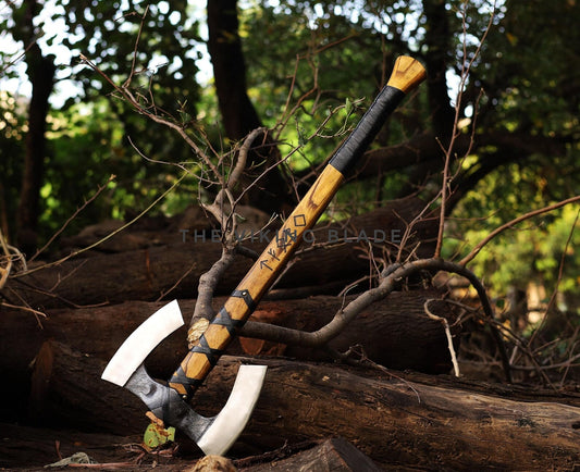 Axes with wooden handles on a log in a forest setting