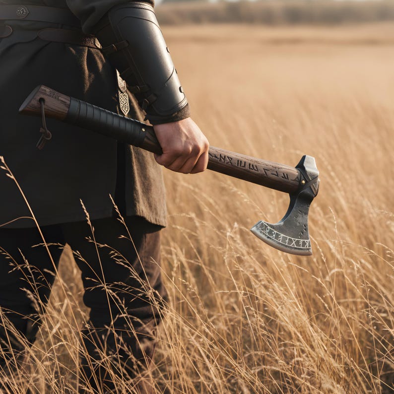 Person holding a axe in a field with a warm color tone