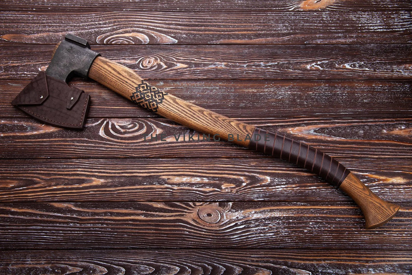 Wooden-handled axe on a wooden surface