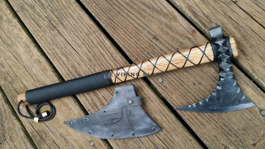Two-handed axe with wooden handle and metal heads on a wooden surface
