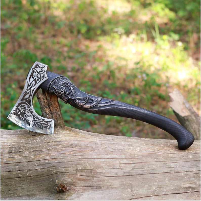 Decorative axe with a black handle on a wooden log outdoors