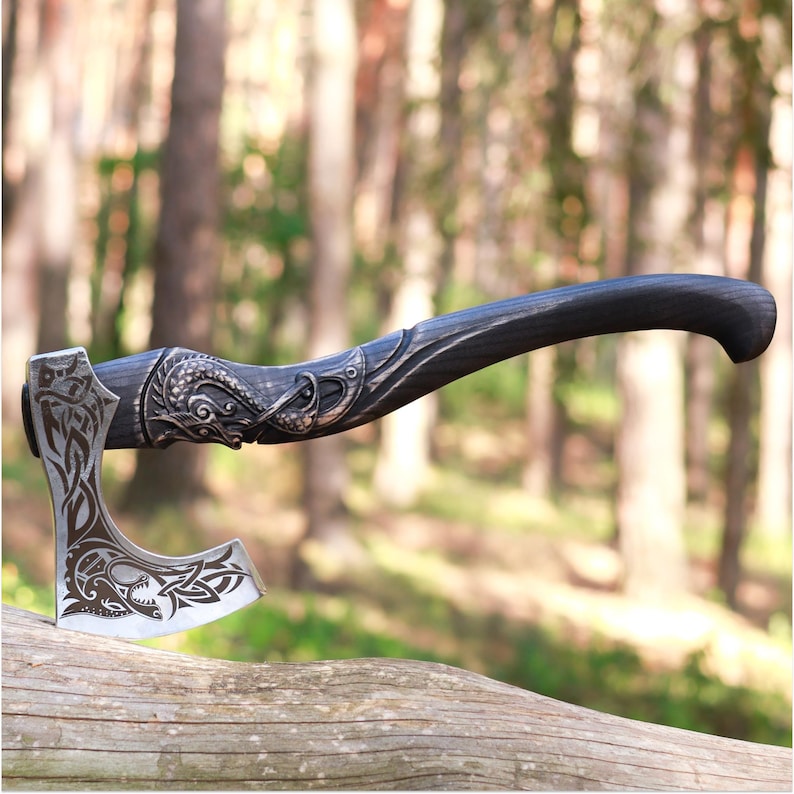 Decorative axe with a detailed handle on a log in a forest setting