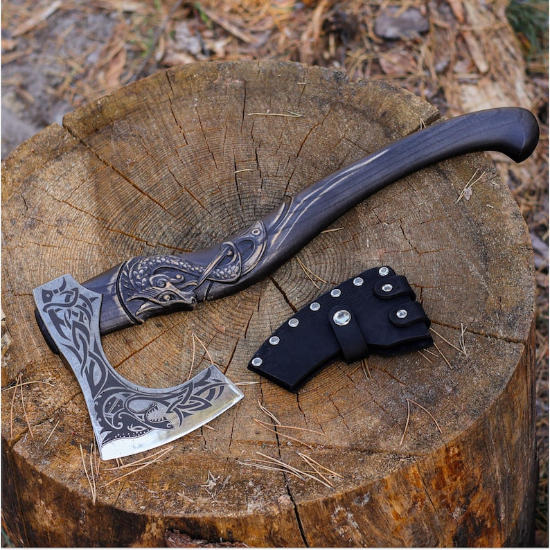 Decorative axe with intricate designs on a wooden stump