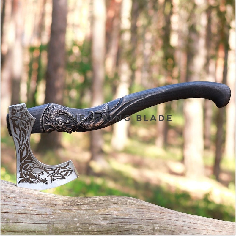Decorative axe with a detailed handle on a log in a forest setting