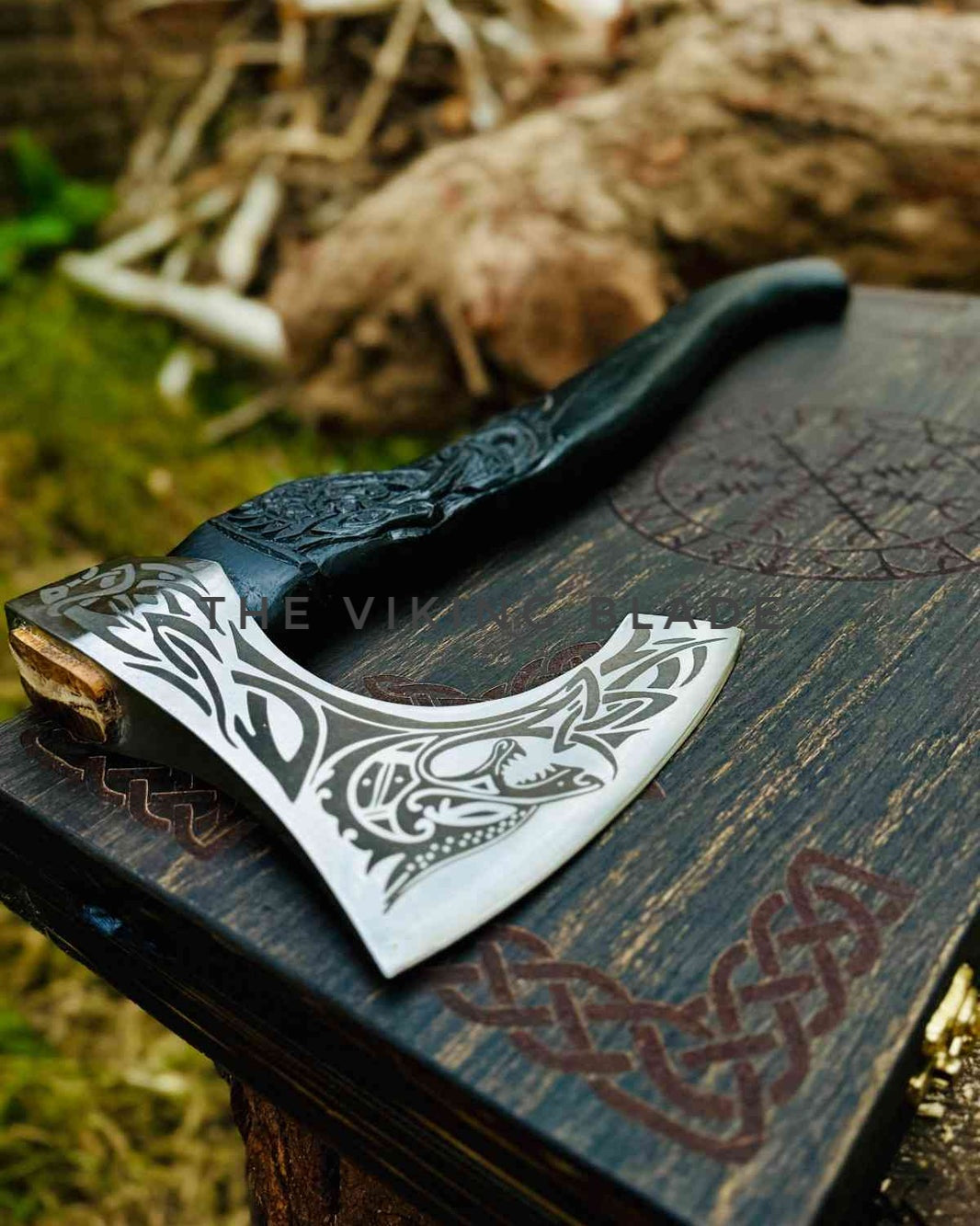 Decorative axe with tribal patterns on a wooden surface outdoors