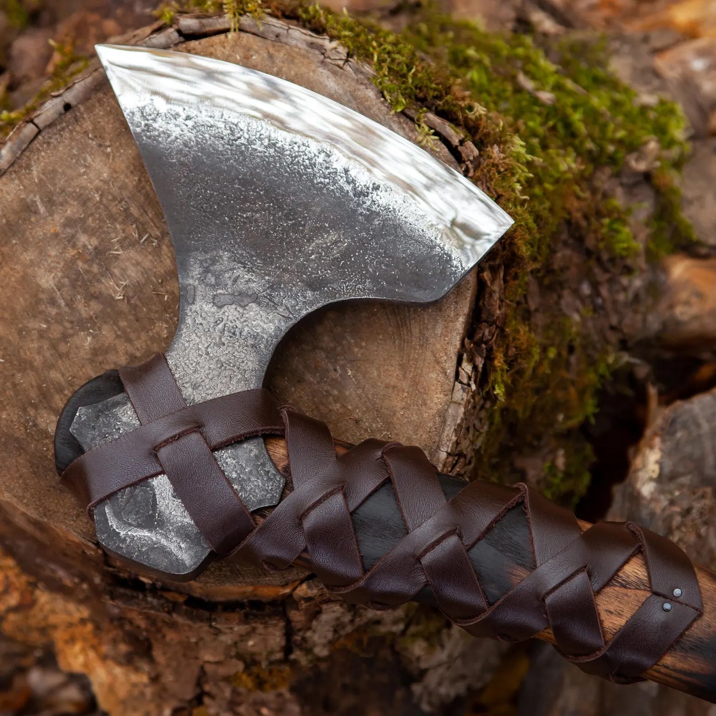 Decorative axe with braided handle on a wooden surface