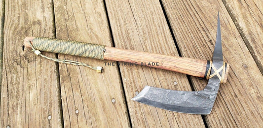 Axes with wooden handles on a wooden surface