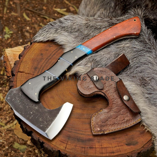 Viking axe with wooden handle and leather sheath on a wooden log