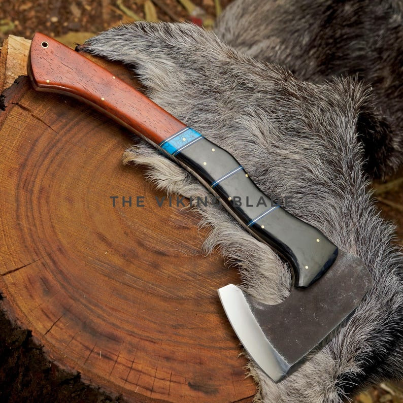 Axes with wooden handles on a fur surface and wooden stump