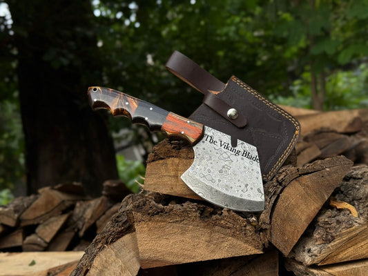 Viking axe with leather sheath on a pile of wood