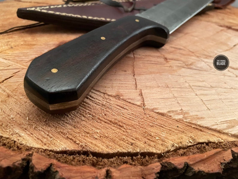 Close-up of the patterned Damascus steel blade on a handmade Seax knife.