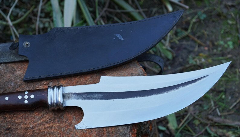 Two knives on a wooden surface with a natural background