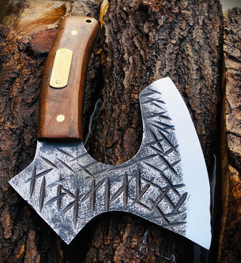 Decorative axe with a wooden handle on a wooden background