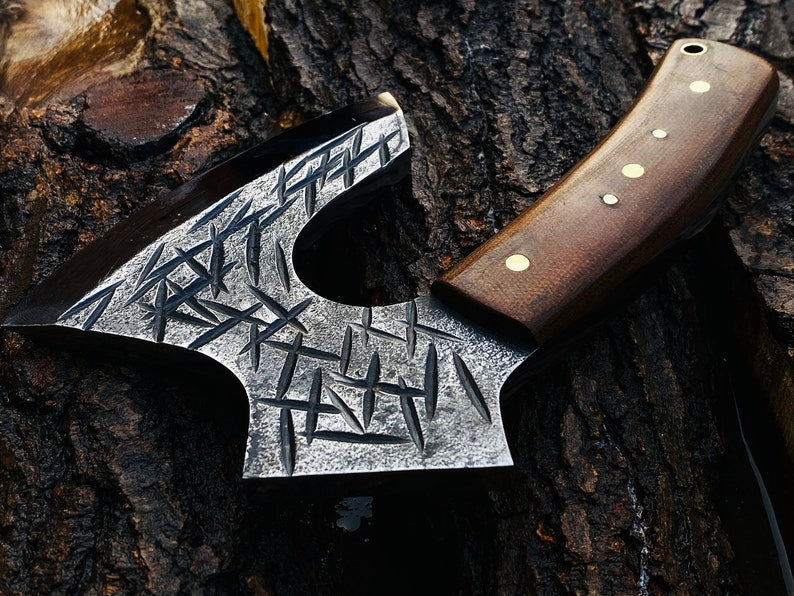 Decorative axe with a wooden handle on a textured surface