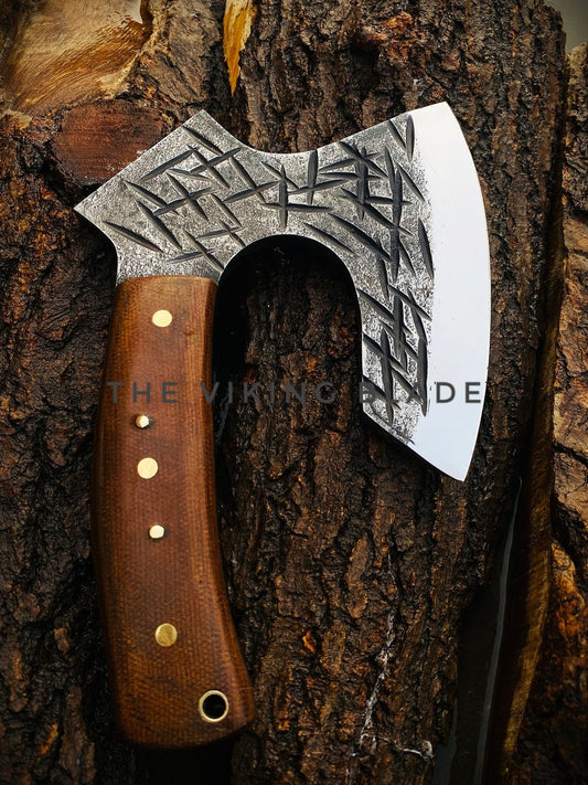 Decorative axe with a wooden handle on a tree stump