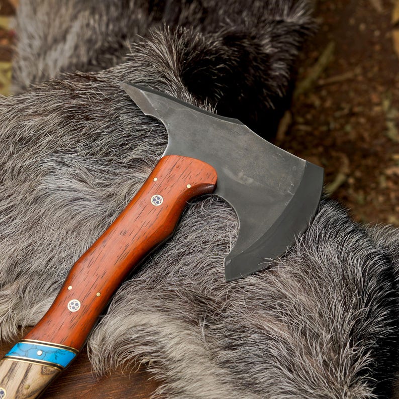 Wooden-handled axe with a metal head on a fur surface