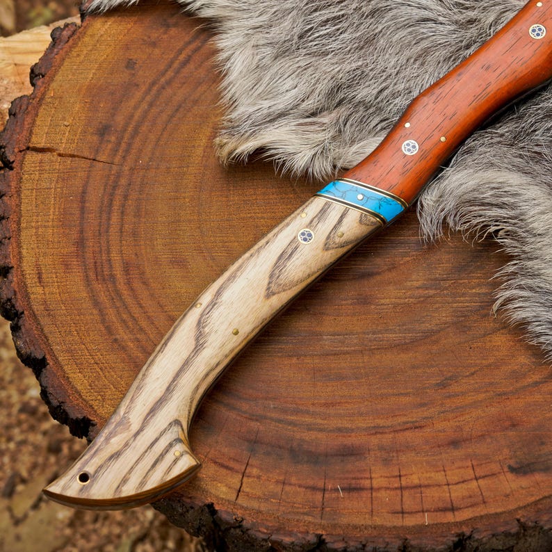 Wooden knife with fur handle on a wooden log