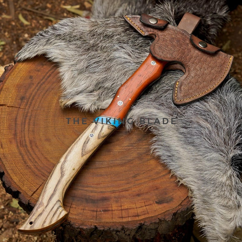 Wooden axe with leather sheath on a wooden stump and fur background