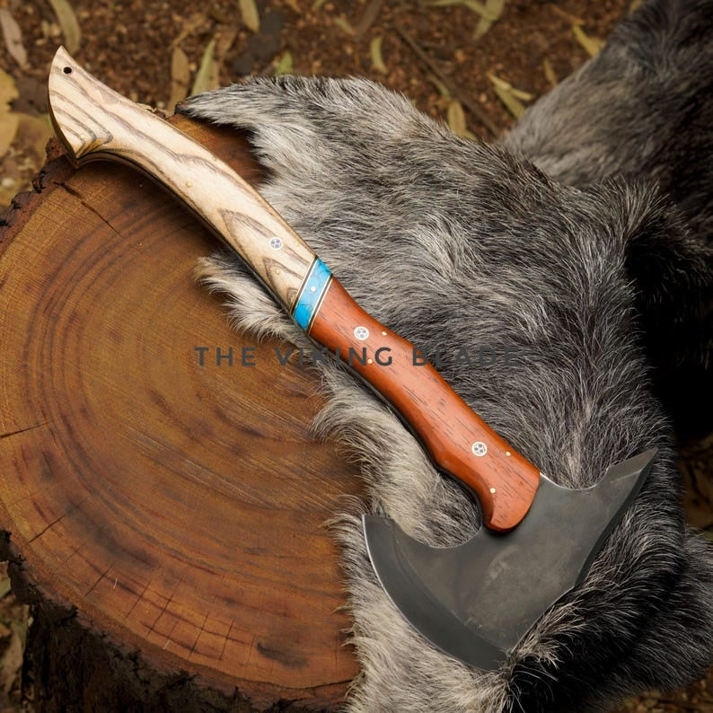 Wooden-handled knife with a metal blade on a fur surface and wooden background