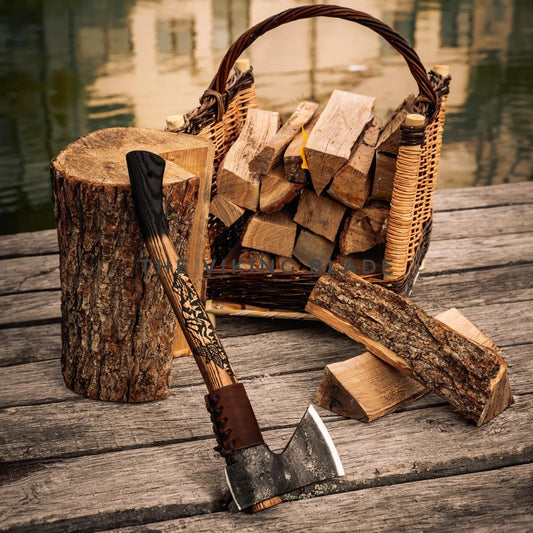 Wooden ax leaning against a log with a woven basket of firewood on a wooden surface.
