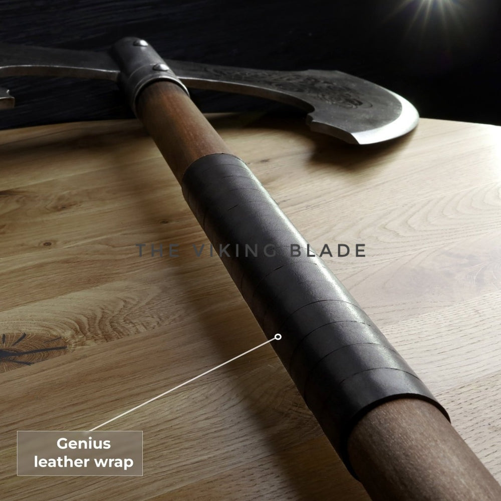 Weapon with a leather wrap on a wooden surface, labeled 'Genius leather wrap'.