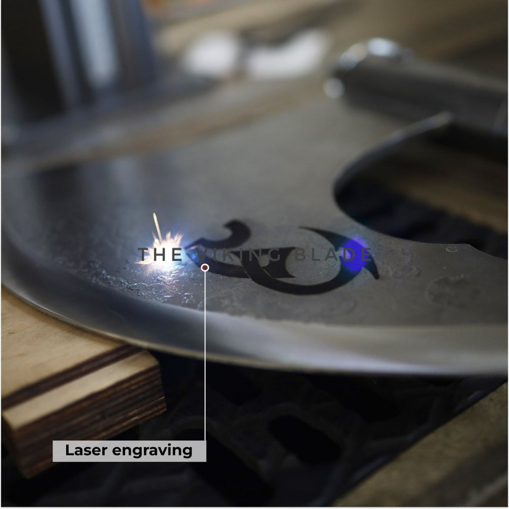 Laser engraving process on a metal surface with sparks