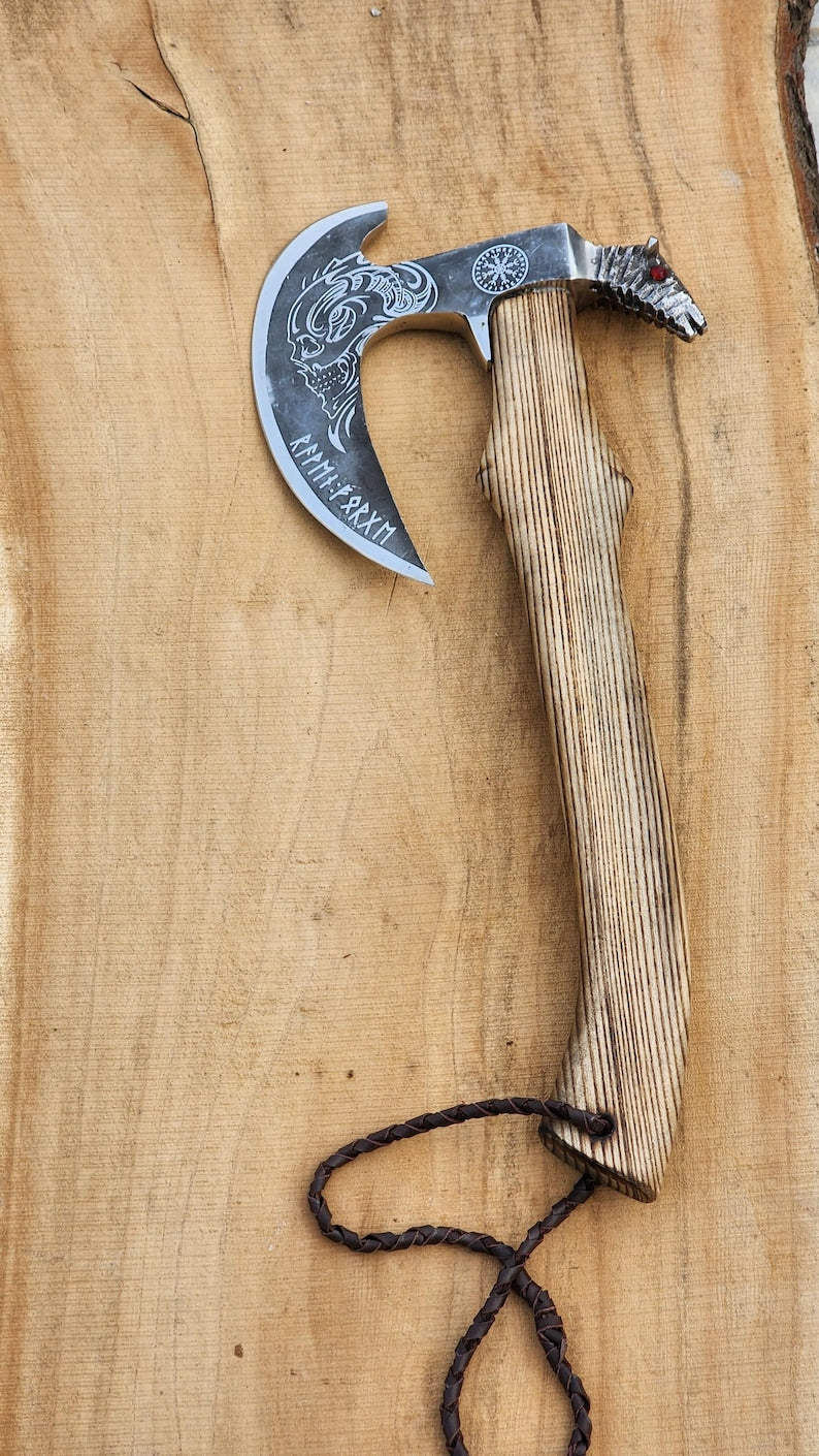 Decorative axe with wooden handle on a wooden surface