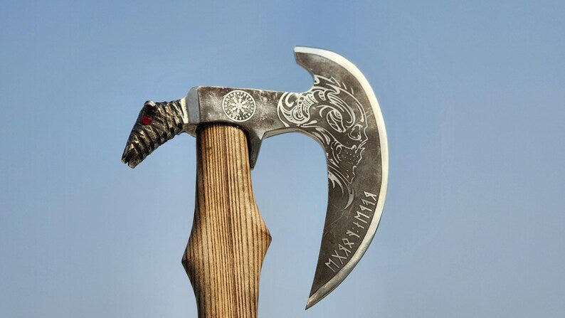 Decorative axe with intricate designs on a clear blue background