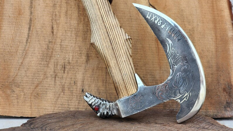 Decorative sickle with intricate design on a wooden background