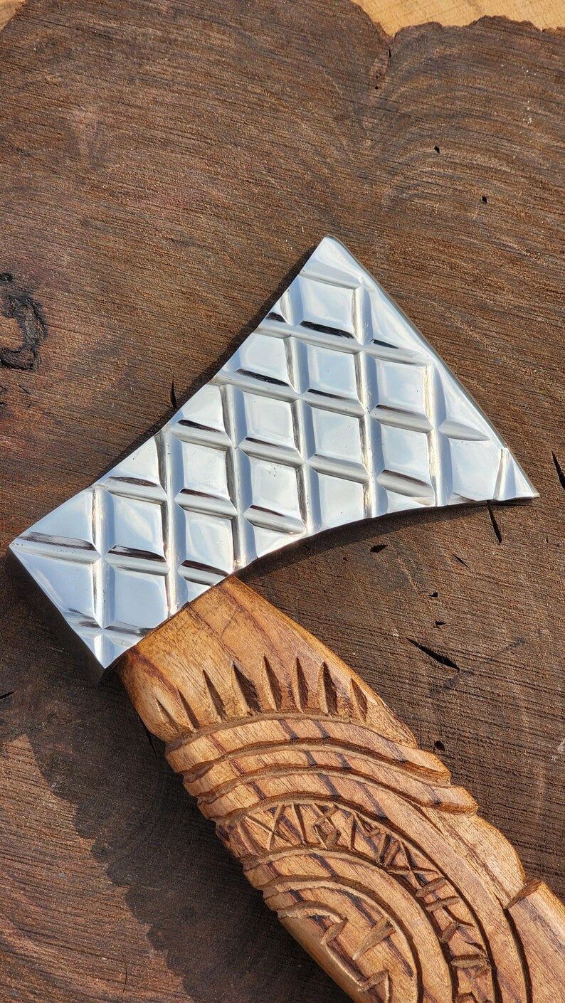 Decorative wooden tool with a metallic square on a wooden background