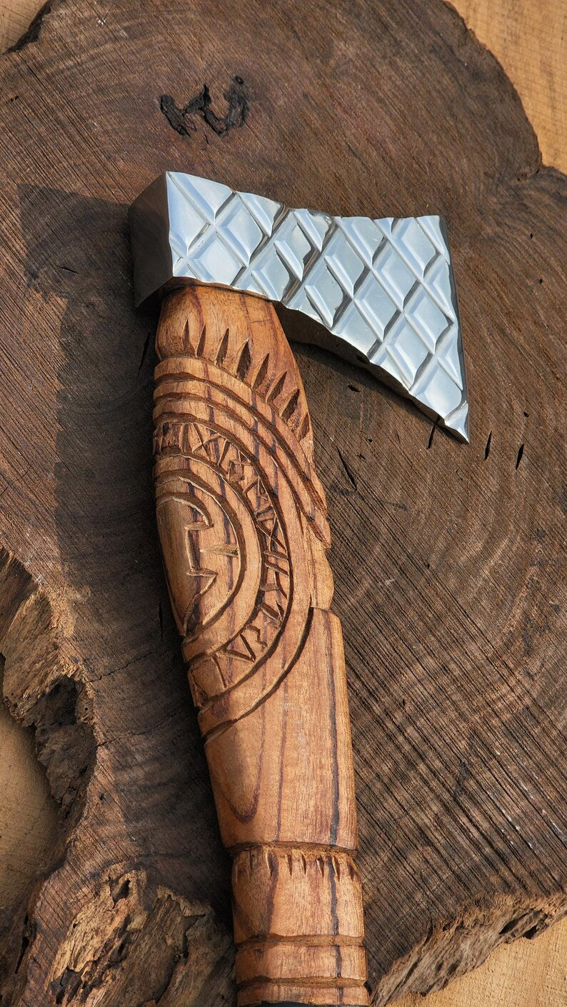 Wooden-handled axe with metal head on a wooden surface