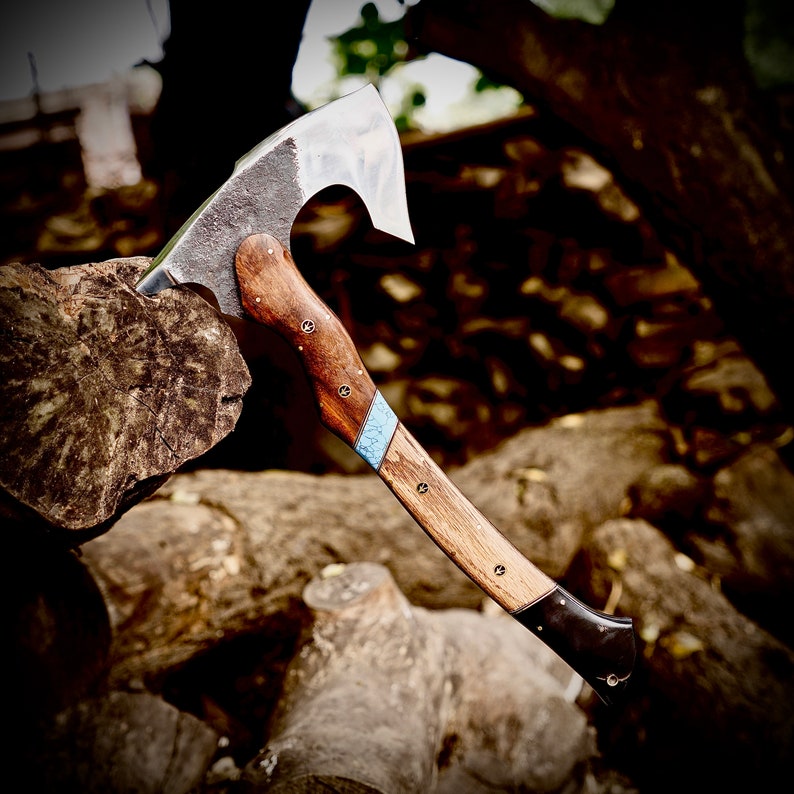 Wooden-handled axe with a metallic blade on a rustic background