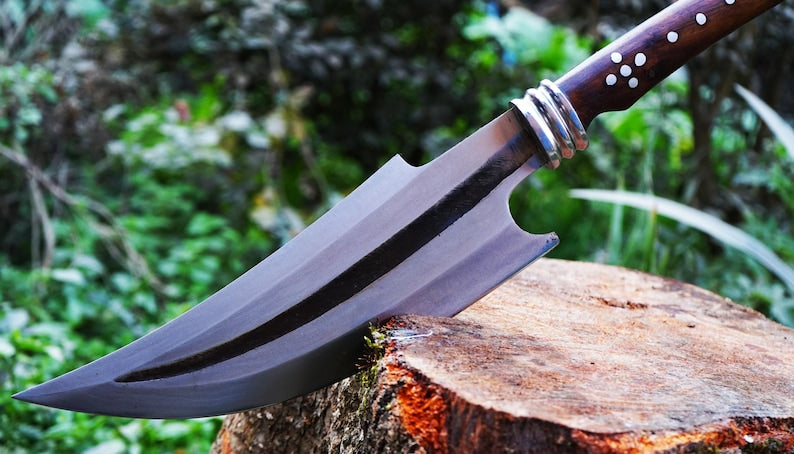 Sword on a wooden stump with a blurred natural background
