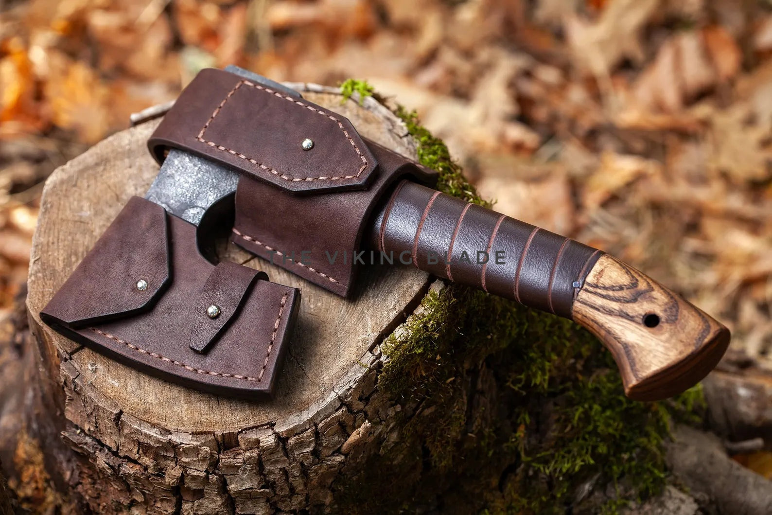 Axes with leather sheaths on a wooden stump in a forest setting