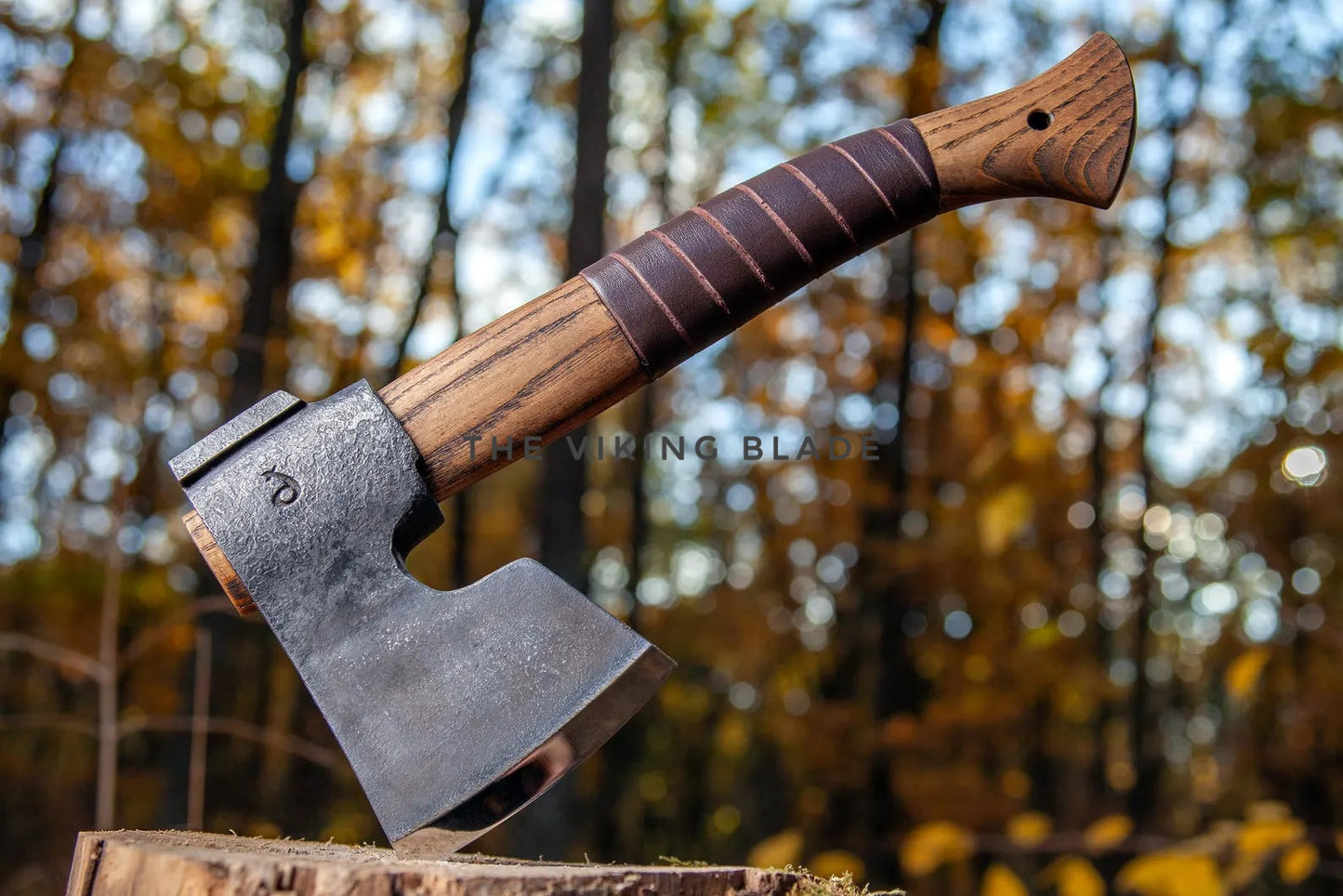 Axes with wooden handles on a blurred forest background