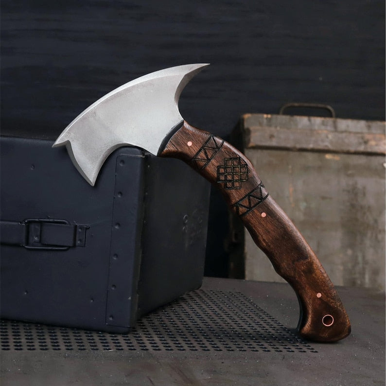 Axes with wooden handles on a dark surface