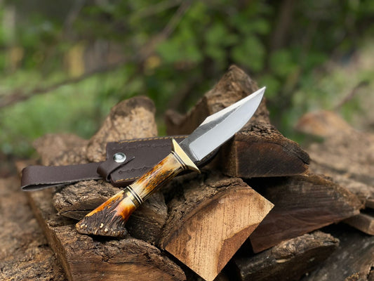 Knife with wooden handle on a stack of wood