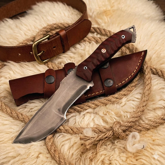 Knife with leather sheath on a textured surface