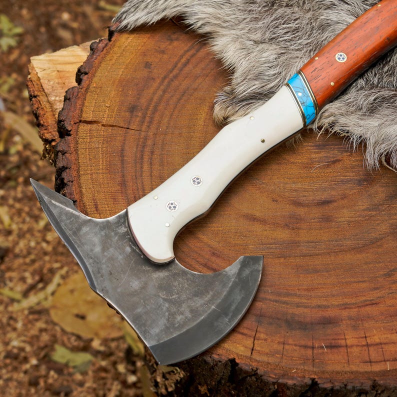 Axes with wooden handles on a wooden surface