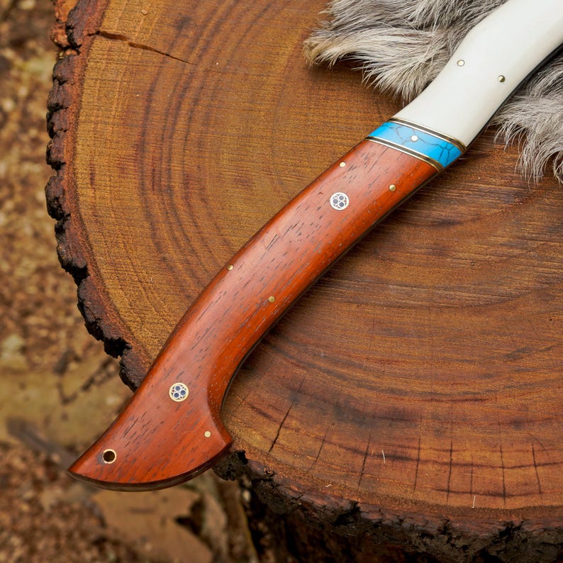 Wooden-handled knife with a white handle and blue accent on a wooden surface