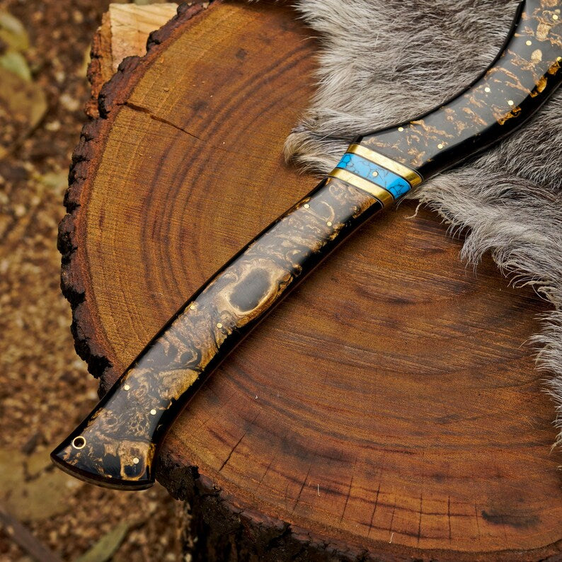 Decorative knife with wooden handle and fur on a wooden surface