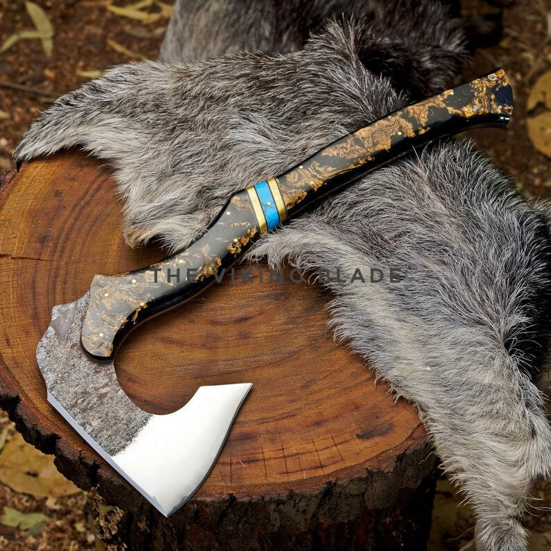 Decorative axe with a decorative handle on a wooden surface