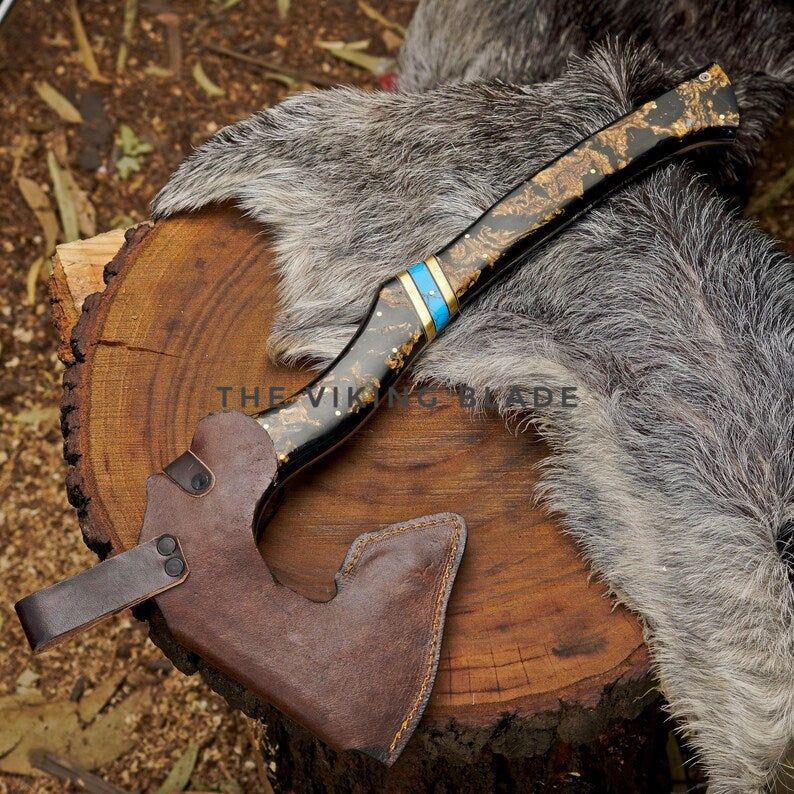 Viking-style axe with leather sheath on a wooden block, surrounded by fur.