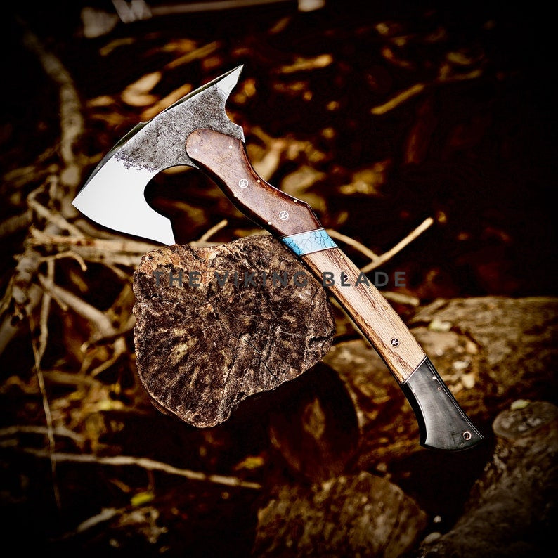 Wooden-handled axe on a dark, natural background