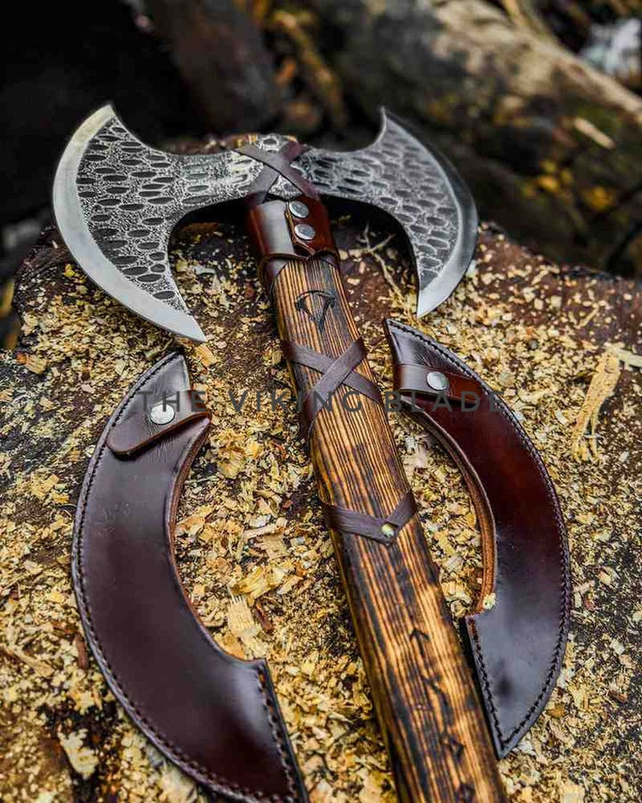 Decorative axe with leather sheathes on a wooden surface