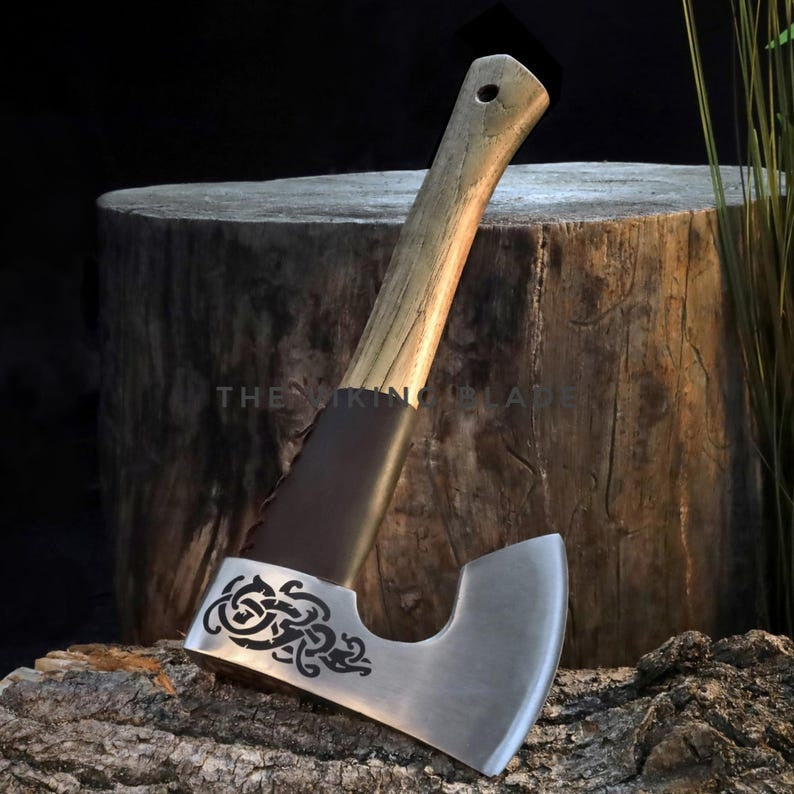Decorative axe with engraved design on a wooden stump