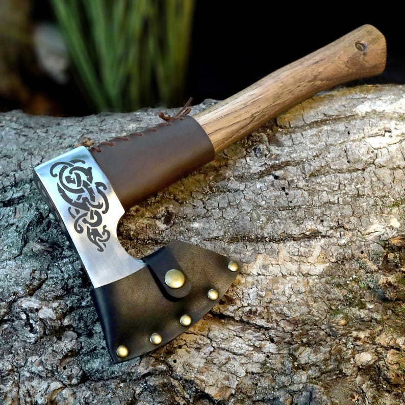 Axes with decorative blade patterns on a wooden background