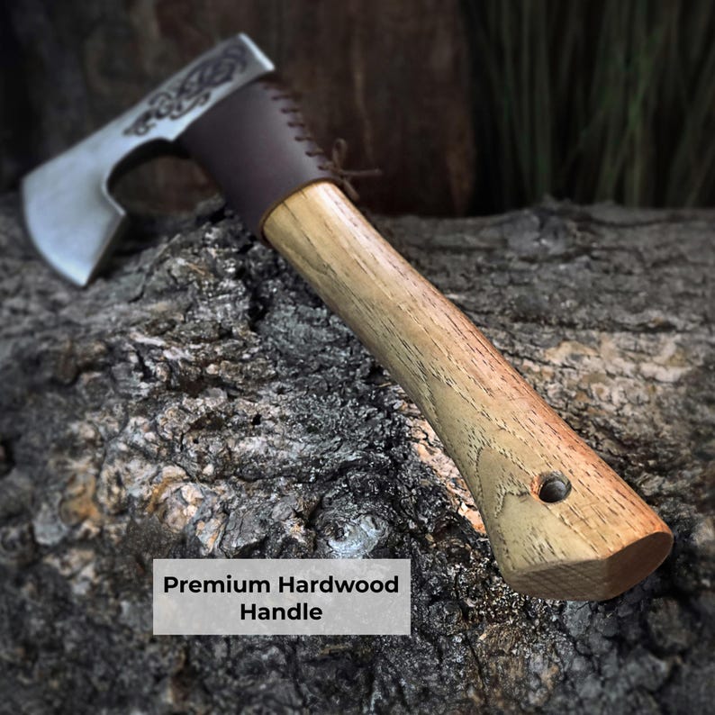 Axes with wooden handles on a textured surface, highlighting the premium hardwood handle.