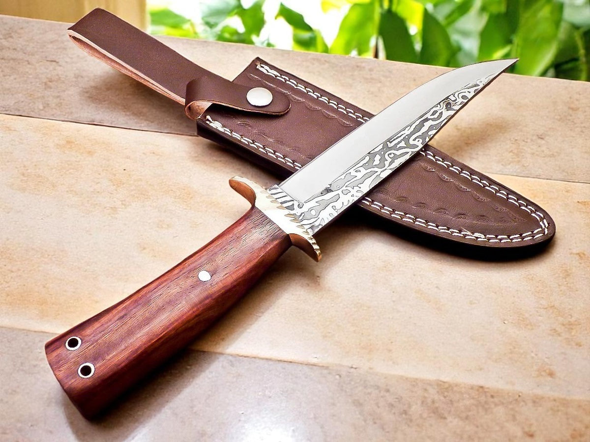 Decorative knife with wooden handle and leather sheath on wooden surface.